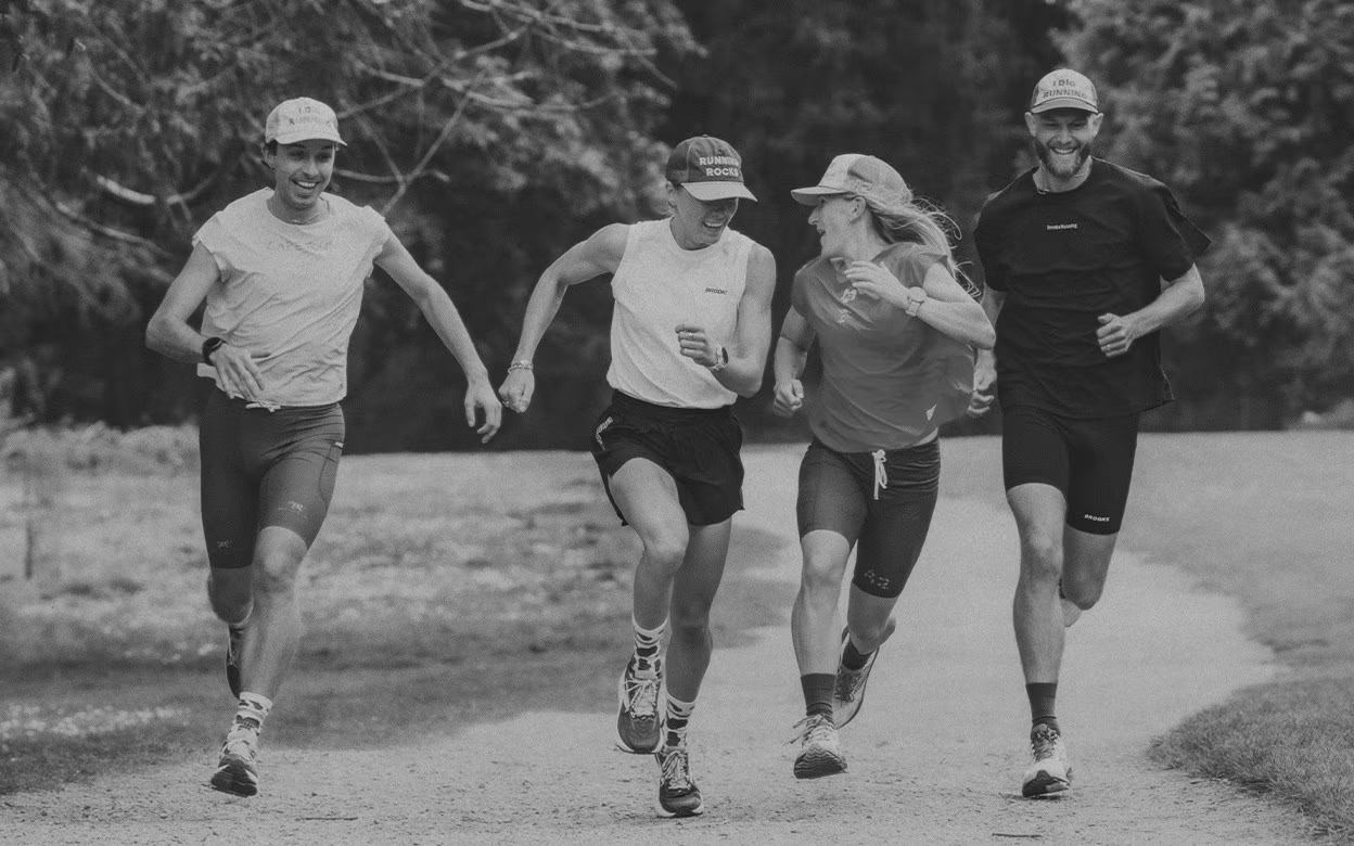 Runners in Brooks gear on a forest path